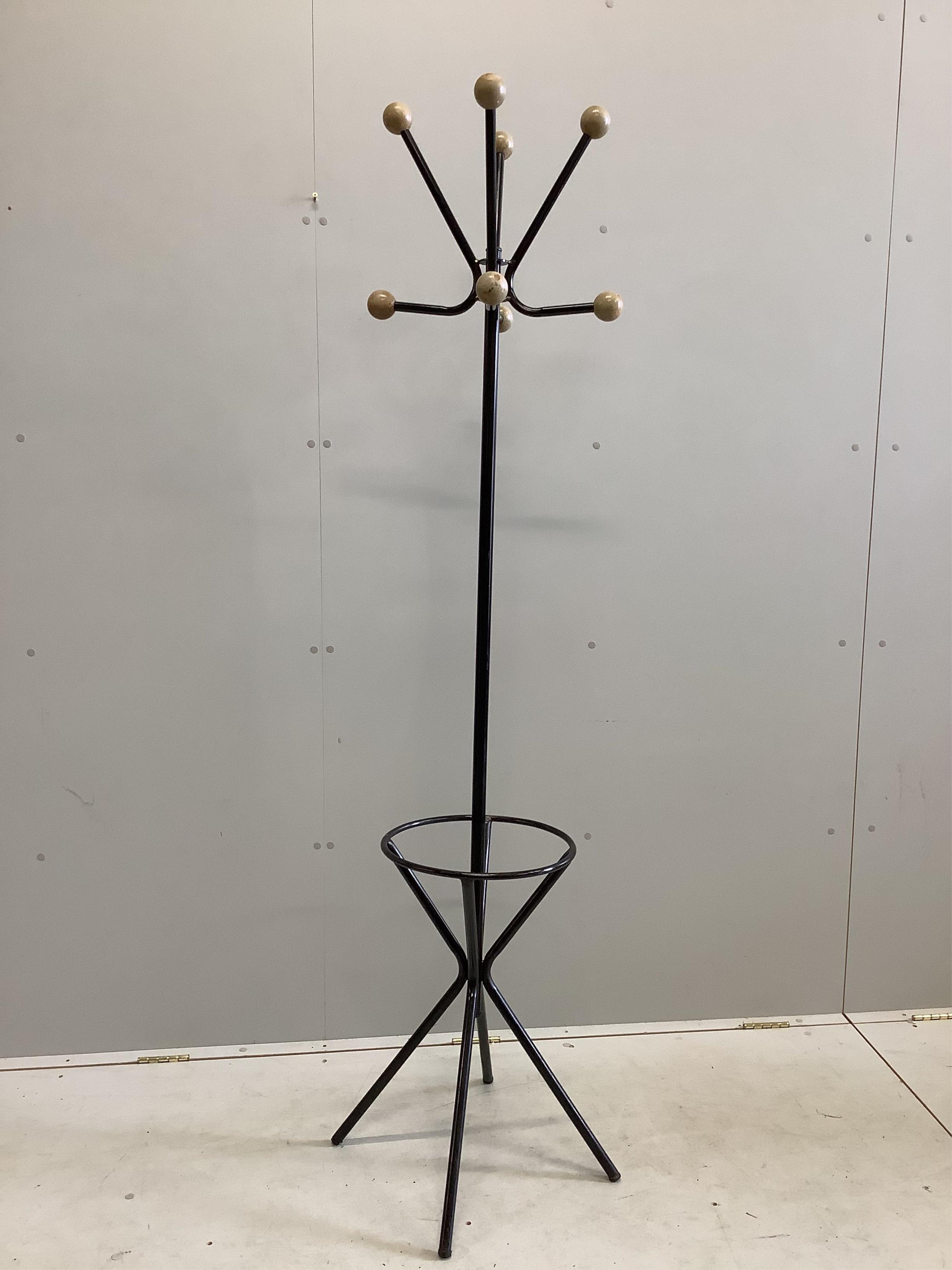 A Contemporary hat and coat stand in waxed black painted steel in the manner of Roger Feraud, c.1960, height 186cm